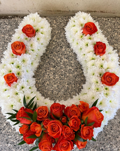 Horse Shoe Tribute - White massed funeral horse shoe tribute with rose/orange roses.