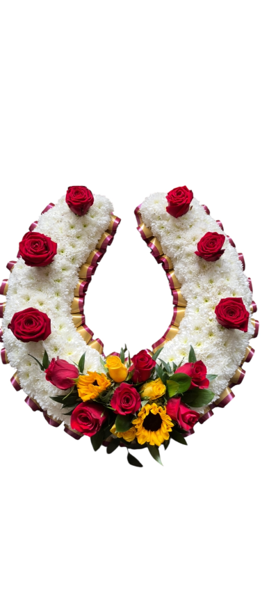 Horse shoe 002 - Horseshoe Tribute
This elegant floral horseshoe tribute is a symbol of good luck and remembrance, crafted with fresh white chrysanthemums and adorned with classic red roses. Finished with a touch of golden ribbon and a spray of vibrant sunflowers, yellow roses, and foliage at the base, this design makes a beautiful and heartfelt tribute for a loved one.