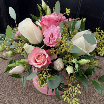 Belle Rose Hat Box - A beautifully arranged hat box featuring soft pink and white blooms, expertly presented to create a stylish gift for any special occasion.