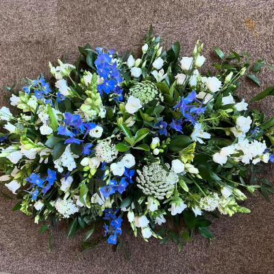 Tranquil Skies Casket Spray - A graceful double-ended casket spray in soothing blue and white tones, thoughtfully designed to offer a heartfelt farewell and lasting tribute.
