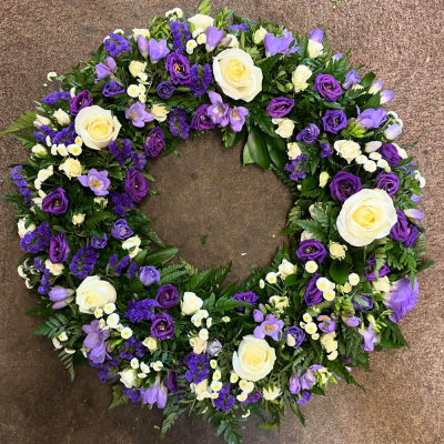 Lavender & Ivory Wreath - A beautifully crafted open wreath in soft white and purple tones, designed to offer a graceful and heartfelt tribute.
