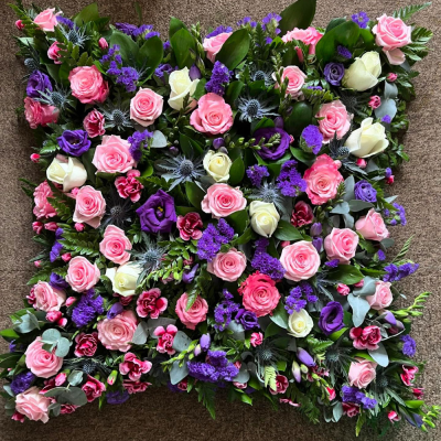 Harmony Tribute Cushion - A beautifully arranged floral pillow tribute in soft pink, white and purple tones, thoughtfully designed to honour a cherished life with grace and elegance.