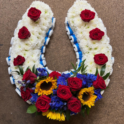 Horseshoe Tribute - A beautifully crafted horseshoe tribute in vibrant red, blue, yellow and white tones, thoughtfully designed to honour a cherished life and celebrate treasured memories.