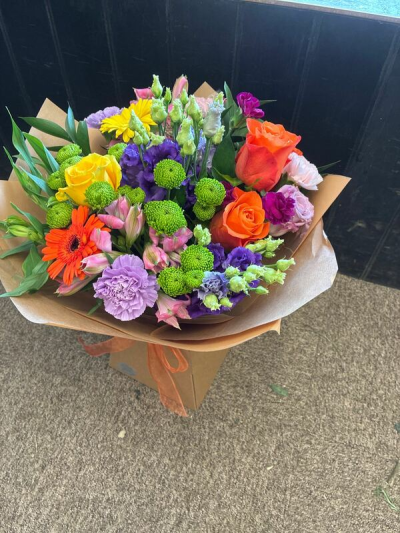 Carnival Colours - A lively hand-tied bouquet full of bold colour and joyful seasonal style.