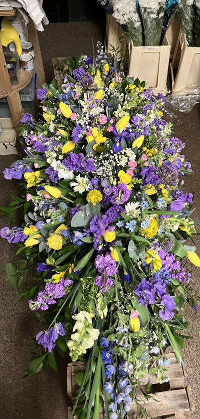 Purple yellow whites coffin spray 0014 - A mixture of yellow, purple and white scented spray, including Stocks freesia, and a mixture of seasonal flowers.