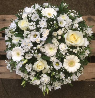 White posy pad 022 - A white Posy pad with green foliage using a mixture of white flower’s which are in season, including gyp, Roses, lizzy  etc